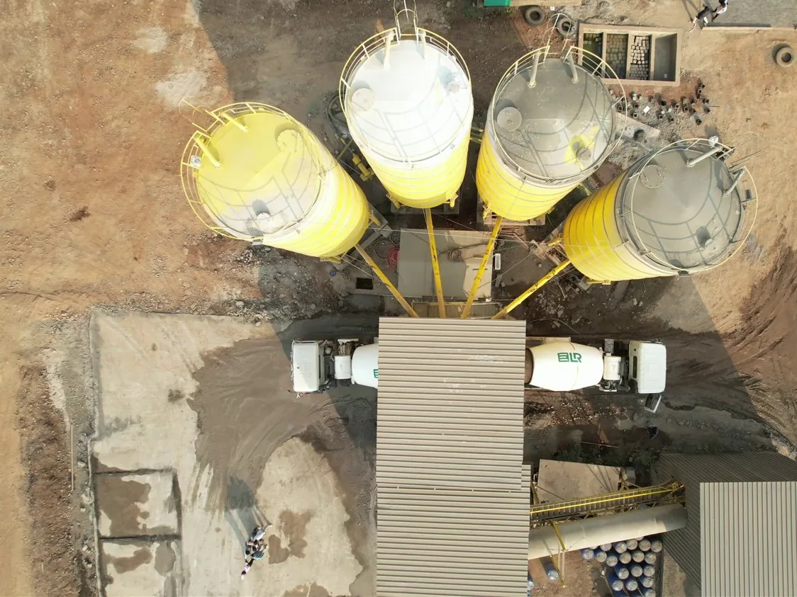 From above: the four cement silos on their arc around the mixer tower, with two ELR mixers in the loading lane