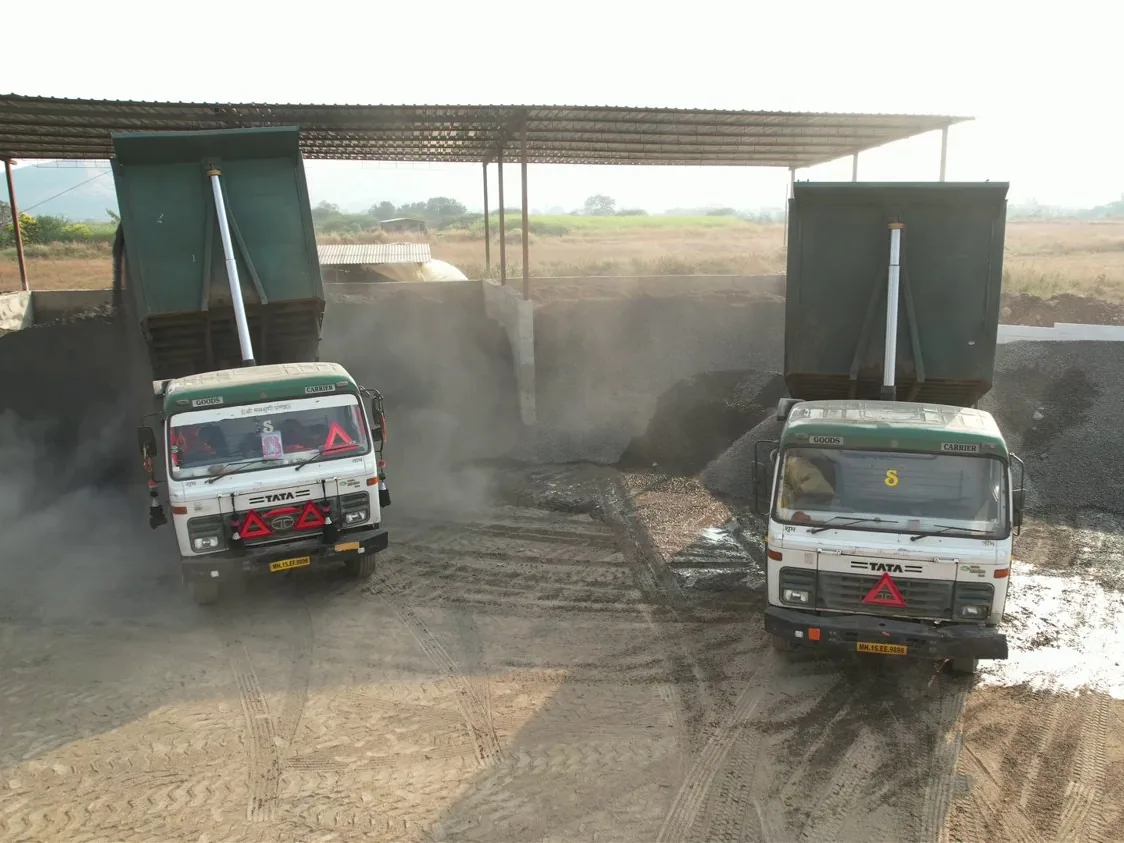 Tippers unloading crushed stone and sand into the roofed aggregate bays at the ELR plant
